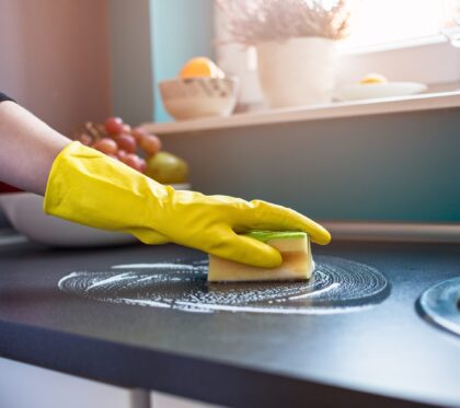 Closeup,On,Woman's,Hands,In,Yellow,Protective,Rubber,Gloves,Cleaning